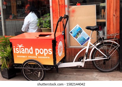 Island Pops Shaved Ice Snow Cone Cart With Green Plants And A Bicycle Outside The Island Pops Store With Man In Window In The Crown Heights Section Of Brooklyn NY On A Sunny Winter Day December 7 2918