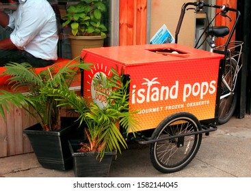 Island Pops Shaved Ice Snow Cone Cart With Green Plants And A Bicycle Outside The Island Pops Store With Man In Window In The Crown Heights Section Of Brooklyn NY On A Sunny Winter Day December 7 2918