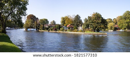Island Riverside houses and canal boat in Rod Eyot, Henley-on-Thames, England.