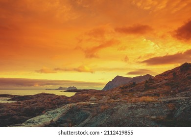 Island in the sea on the horizon. Rocks in the sea during sunset. Beautiful rocky sea landscape in evening. Wild nature Norway, Lofoten islands seascape.  - Powered by Shutterstock