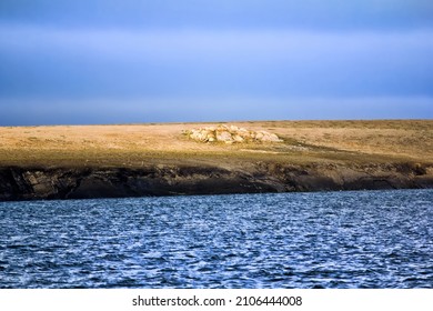 Islands In Arctic Ocean. Coast Of Island Vaigach Near Yugorski Shar Strait: Rocky Cliff And Tundra. Polar Zone, One Of Sites Northeast Passage At White Night (midnight Sun). Russia