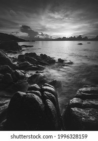 Island's Dawn View At A Peaceful Rocky Beach Bay With Dramatic Sky And Rock Formation Background. Long Exposure With Blurred Tides And Wave Motion. Black And White. Koh Samui, Thailand.