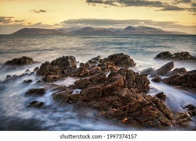 Isle of Arran in the evening from a rocky coastline on Kintyre