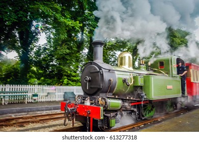 Isle Of Man, Douglas, 7 June 2016: Hogwarts Express. Steam Train On Railroad Station With Blurred Background. Green Steam Train On Rail Station. Steam Railway Road Isle Of Man. Hogwarts Express Train