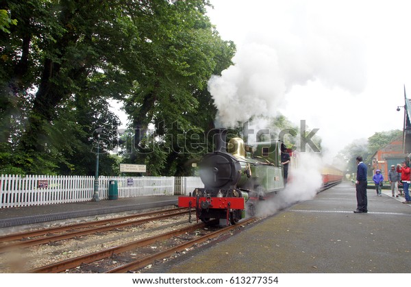 Isle of Man, Douglas, 7 June 2016: Vintage Steam\
train on railroad station. Old Green steam train on rail station.\
Historic Steam railway road Isle of Man. Historic passenger train.\
Old Vintage train