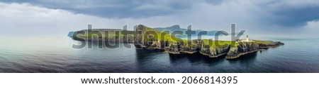 Isle of Skye, Scotland - September 8, 2021:  Overcast skies and gathering storm over Point of Neist Light House, Isle of Skye, Scotland