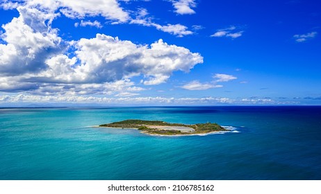 Islet in atlantic ocean. Small atoll in ocean. Tropical bliss in carribbean land. View on island from hill. Aquatic heaven and isle paradise. Touristry place for relax. - Shutterstock ID 2106785162