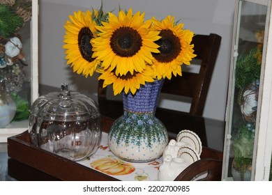 Islip Terrace, NY, USA, 9.15.22 - A Bouquet Of Sunflowers In A Vase. The Flowers Are In A Tray With Turkey Candle Holders And An Empty Pumpkin Shaped, Glass, Cookie Jar.