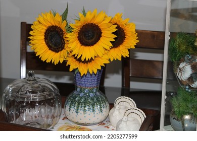 Islip Terrace, NY, USA, 9.20.22 - A Fall Themed Centerpiece. A Bouquet Of Sunflowers In A Vase. The Flowers Are In A Tray With Turkey Candle Holders And An Empty Pumpkin Shaped, Glass, Cookie Jar.