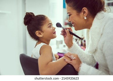 Isnt That Enough Blusher Already, Mom. Shot Of A Mother Applying Makeup To Her Cute Little Girl In A Dressing Room.