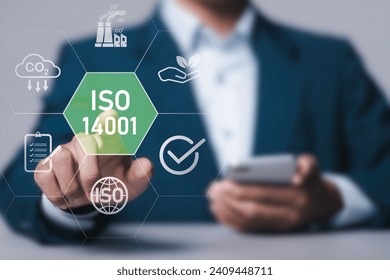 ISO 14001 concept. Businessman with ISO 14001 certified for environmental management systems (EMS). Identify, control and reduce the environmental impact of activities.