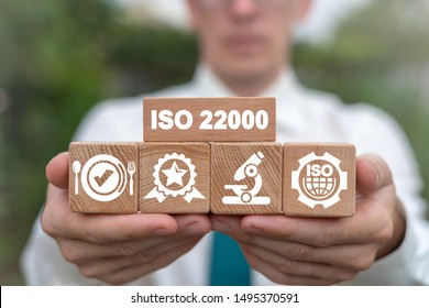 ISO 22000 Food Standard Assurance Control Certification. Man holding wooden blocks with iso 22000 certificate.