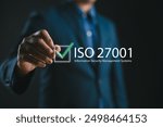 ISO 27001 concept. requirements, certification, management, standards. Businessman using tablet to choose ISO 27001 for information security management system (ISMS). 