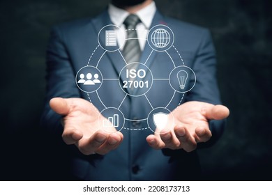 ISO 27001 and icons. Man holding in his hand