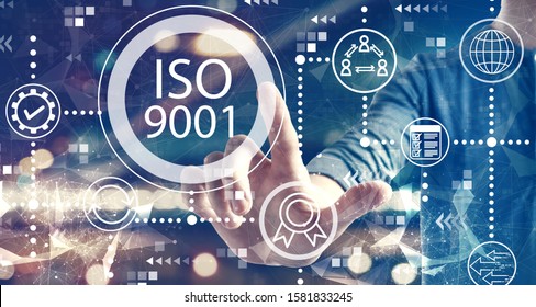 ISO 9001 Concept With A Man On Blurred City Background