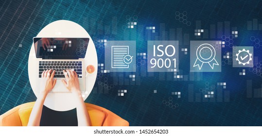 ISO 9001 With Person Using A Laptop On A White Table