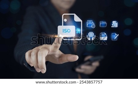 ISO certification, and standardization notion as proof of top service.Businessman touching Quality assurance icon on digital screen for ISO certification and standardization.