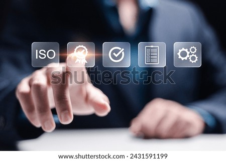 ISO Certification and standardization process concept. Certificate, Approval, Compliance to requirements. Businessman touching quality assurance icon for international standards.