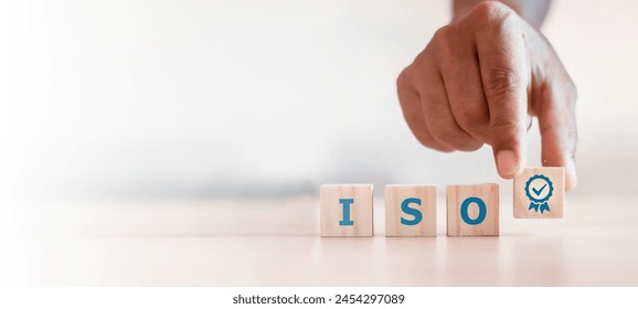 ISO quality control certification concept. wooden cubes with the abbreviation ISO with a check mark.