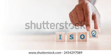 ISO quality control certification concept. wooden cubes with the abbreviation ISO with a check mark.