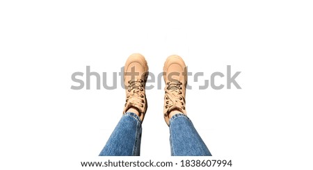 isolate on a white background. feet of a young girl in jeans and calamity shoes on a white background. space for text