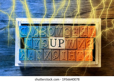 UP - isolated abstract in blue and orange wood type stamps and lightning or thunder against wooden background and copy space.close up.