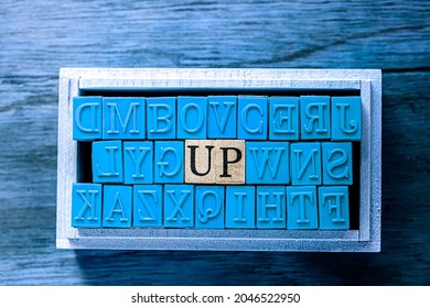 UP - isolated abstract in blue wood type stamps against wooden background and copy space.close up.