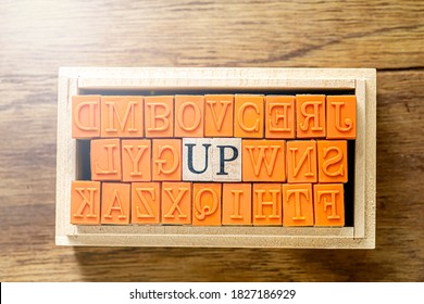 UP - isolated abstract in wood type stamps against wooden background and copy space.close up.