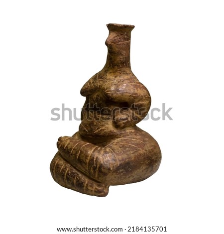 Isolated ancient figurine on a white background. Figurine of a seated woman from the Neolithic period