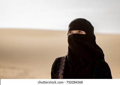Isolated Arabic/Saudi woman portrait and desert background. - Shutterstock ID 750284368