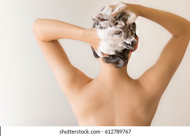 Isolated Back Shot Of A Sexy Model Shampooing Her Hair With Lots Of Suds.