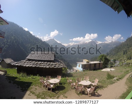 Isolated backpacker retreat - Seating area in the mountains and clouds view from a guest house / restaurant in Tosh village, Parvati Valley, Himachal pradesh, India. 