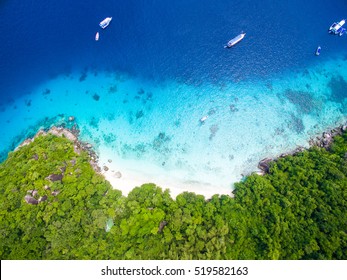 Isolated Beautiful Tropical Island With White Sand Beach And Blue Clear Water And Granite Stones. Top View, Speedboats Above Coral Reef. Similan Islands, Thailand.