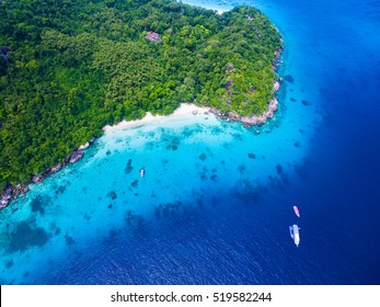 Isolated Beautiful Tropical Island With White Sand Beach And Blue Clear Water And Granite Stones. Top View, Speedboats Above Coral Reef. Similan Islands, Thailand.