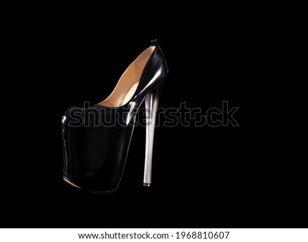 isolated black shoes threesome strips on very high heels on a black background. Shoes for strip plastic, pole dance, exotic. Beautiful closed stiletto heels