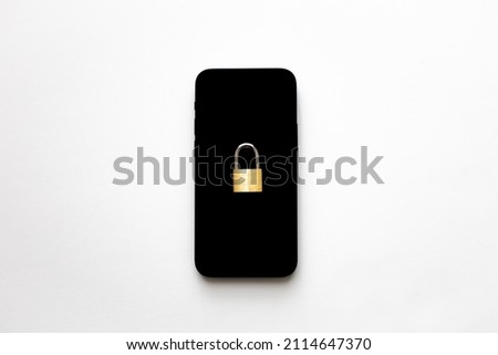 An isolated black smartphone with a small padlock on it on white background. Phone protection idea. Online data privacy protection concept. Protection against cyber attack.