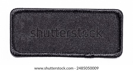 Isolated blank black rectangular patch with rounded edges.