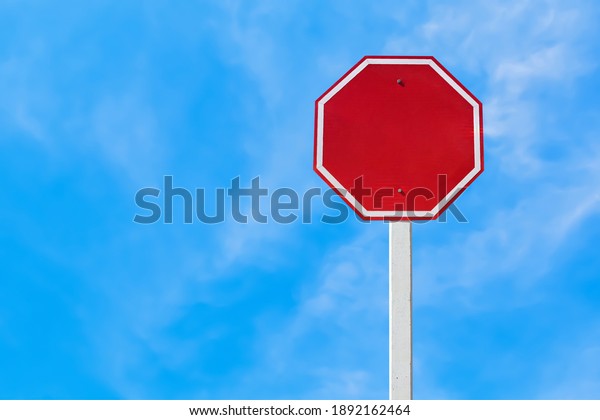 Isolated blank red traffic sign on pole with\
clipping paths.