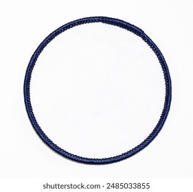 Isolated blank white circle patch with dark blue trim.