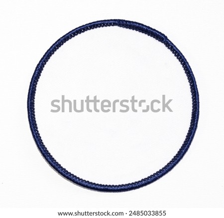 Isolated blank white circle patch with dark blue trim.