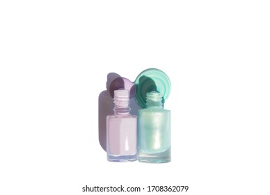 Isolated Bottles Of Purple Pink And Mint Blue Nailpolish With Shadow And Spill