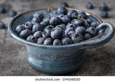 Isolated Bowl Of Blueberries In A Vintage Serving Dish. Above Shot, Dark Background.