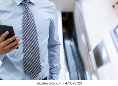 isolated business man hold the smartphone on shopping mall background
 - Shutterstock ID 473875723