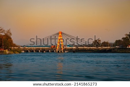 isolated cable bridge over ganges river with colorful sky at evening image is taken at haridwar uttrakhand india.
