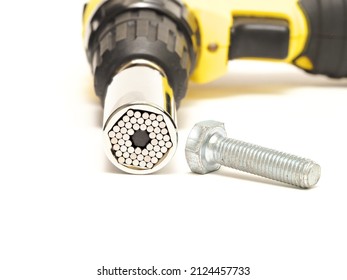Isolated chrome universal socket wrench able to open different sized bolts. Cordless screwdriver, Selective focus. - Shutterstock ID 2124457733