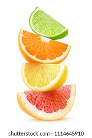 Isolated citrus slices. Pieces of grapefruit, orange, lemon and lime fruits on top of each other isolated on white background with clipping path - Shutterstock ID 1114645910