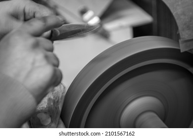 Isolated Close Up Of Chef Knife Sharpening, Honing And Stropping Process By  A Skilled Craftsman. Vintage Old School Craftsman At Work In Grange Shop Showing True Professional Skills.