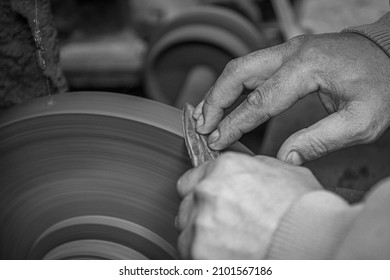 Isolated Close Up Of Chef Knife Sharpening, Honing And Stropping Process By  A Skilled Craftsman. Vintage Old School Craftsman At Work In Grange Shop Showing True Professional Skills.