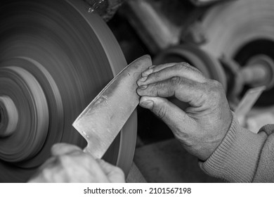 Isolated Close Up Of Chef Knife Sharpening, Honing And Stropping Process By  A Skilled Craftsman. Vintage Old School Craftsman At Work In Grange Shop Showing True Professional Skills.