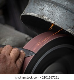 Isolated Close Up Of Chef Knife Sharpening, Honing And Stropping Process By  A Skilled Craftsman. Vintage Old School Craftsman At Work In Grange Shop Showing True Professional Skills.